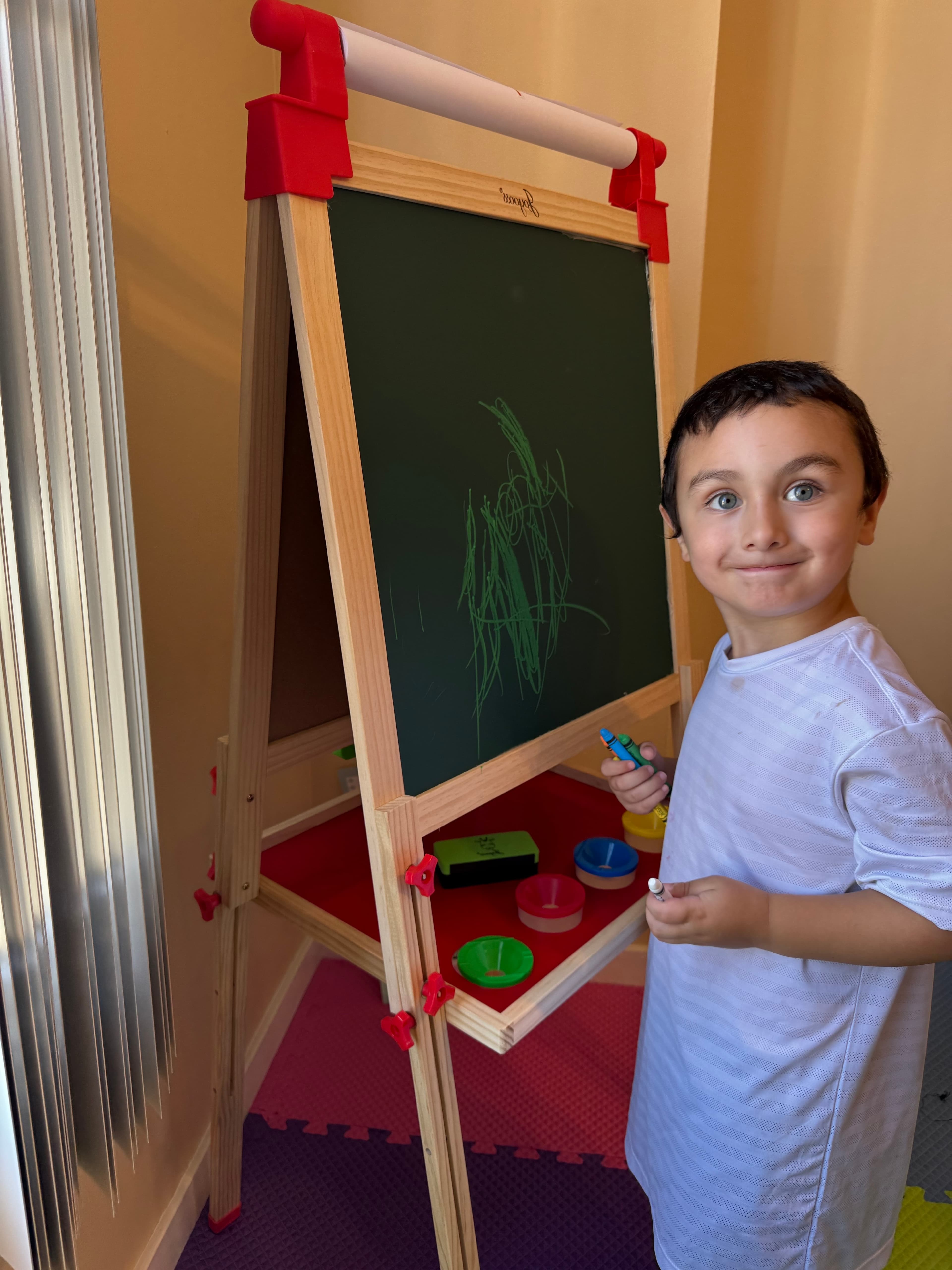 Children playing in colorful indoor playroom at Mae's Childcare